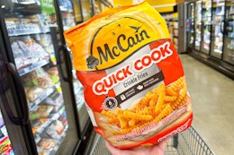 hand holding a bag of mccain fries