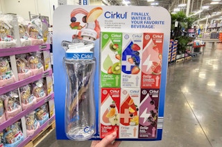 person holding a cirkul water bottle with cartridges