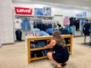 a person looking in the levi section at macy's