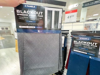 someone holding blackout curtains