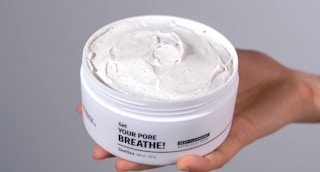 hand holding a jar of zealsea clay deep cleansing facial mask