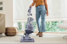 Woman cleaning with the Shark NV352 Navigator Lift Away Upright Vacuum cleaner.