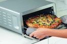 pizza coming out of an air fryer