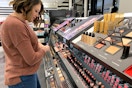 Woman looking at makeup in Sephora.