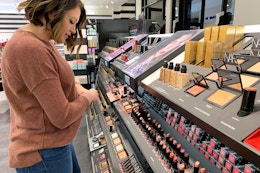 Woman looking at makeup in Sephora.