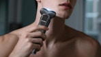 a person using an electric razor on their face 