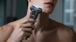 a person using an electric razor on their face 