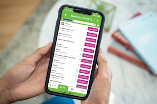 someone holding phone with InboxDollars on it