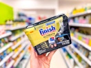 hand holding FInish Ultimate dishwashing tabs