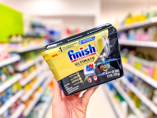 hand holding FInish Ultimate dishwashing tabs