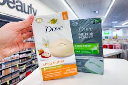 hand grabbing Dove and dove men bar soaps