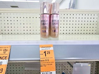 bottles of foundation by a $1.29 clearance sign