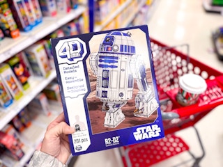 hand holding a 4d build star wars r2-d2 kit at target
