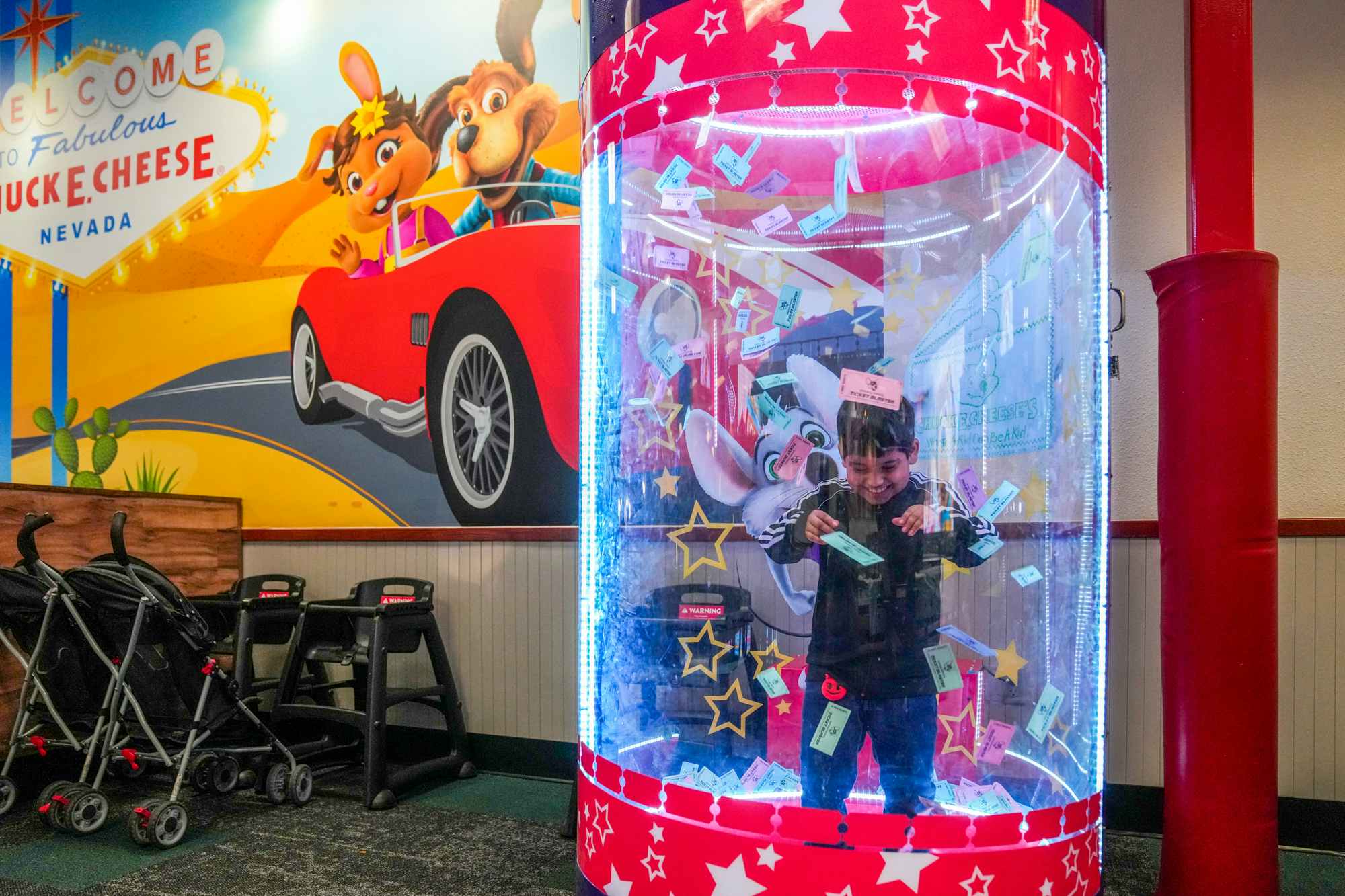 A child in the ticket blaster at Chuck E Cheese