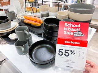 dinnerware set next to a 55% off sign