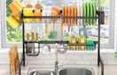 a rack of dishes over a kitchen sink