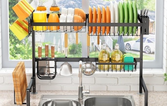a rack of dishes over a kitchen sink