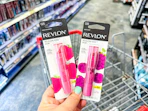 hand holding revlon lip balms in cvs