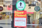 sign on a CVS entrance saying store is closed     