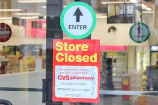 sign on a CVS entrance saying store is closed