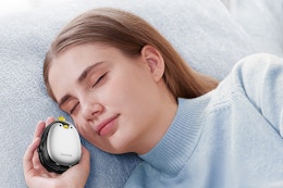 a woman holding penguin hand warmers