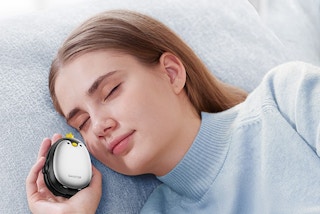 a woman holding penguin hand warmers