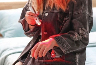 someone using Rosa Rugosa LED Red Light Therapy Device for Joint and Muscle Pain on their hand