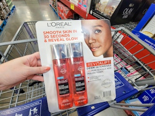 hand holding a 2-pack of loreal paris glycolic acid toner in a cart