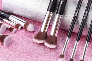 makeup brushes on a glitter background