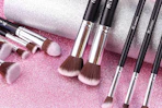 makeup brushes on a glitter background