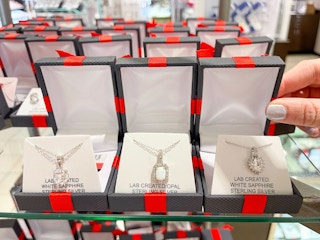 display of jewelry in red and black boxes