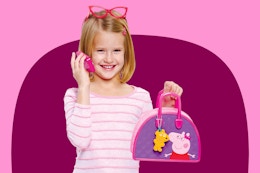 Stock image of the Peppa Pig Bag Set being held with a girl holding the pretend phone up to her ear with red glasses on her head