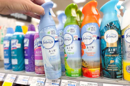 person grabbing febreze air freshener from a shelf