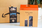 an amazon fire tv stick box sitting in front of an Amazon box on counter