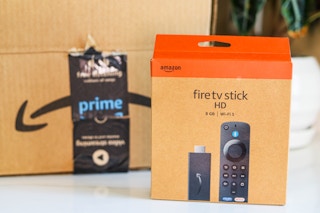 an amazon fire tv stick box sitting in front of an Amazon box on counter