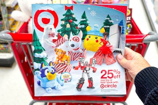 a person holiday the target toy book in store in front of cart 