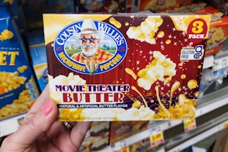 hand holding a box of cousin willies popcorn