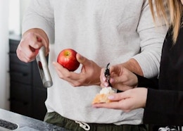 a man using an apple corer