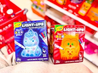 hand holding 2 crayola light-ups craft kits at target
