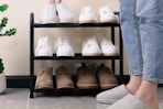 woman placing shoes on rack