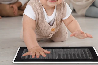 a baby over a vent screen