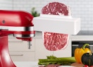 a meat tenderizer with a steak on a stand mixer