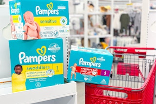 pampers diapers and wipes sitting on table in front of a target cart