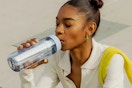 a woman using a lifestraw filter water bottle