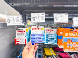 hand holding blistex lip balm hanging with price tag at walmart