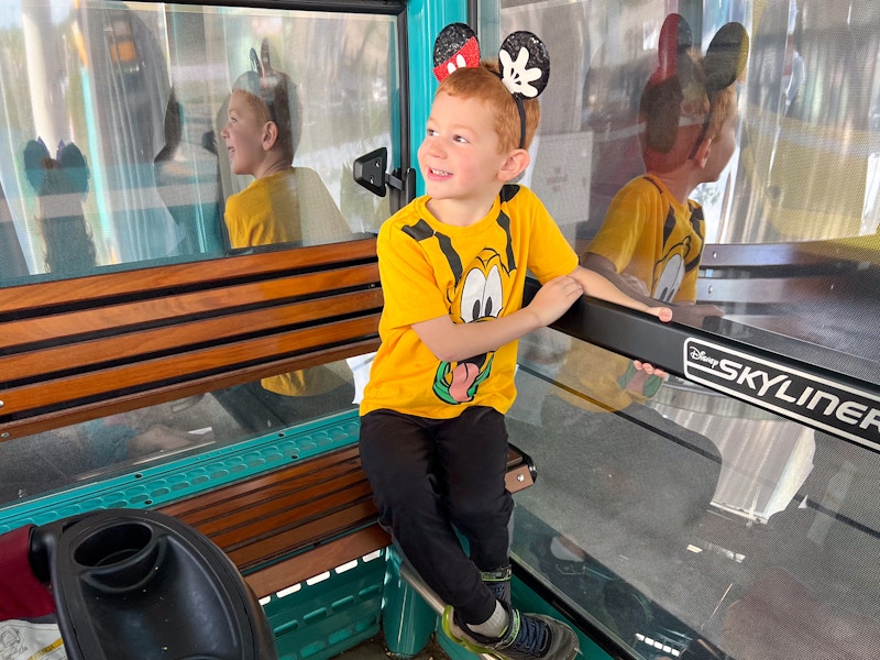 a child riding the disney skyliner at disney world