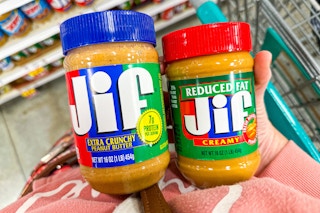 hand holding jars of jif peanut butter