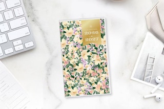 lifestyle image of a planner on a counter near a computer