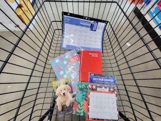 cart with a variety of planners in it at dollar tree