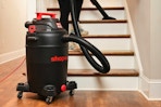 Lifestyle image of the 16-gallon Shop Vac being used on in-door staircase